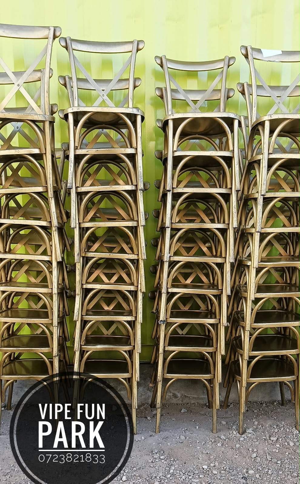Stacks of gold-toned cross-back event chairs at Vipe Fun Park