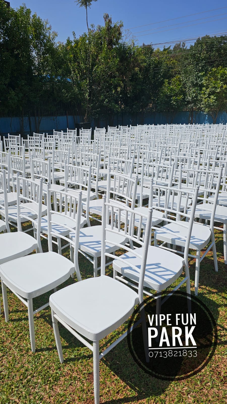 Rows of white event chairs arranged outdoors on the Vipe lawn