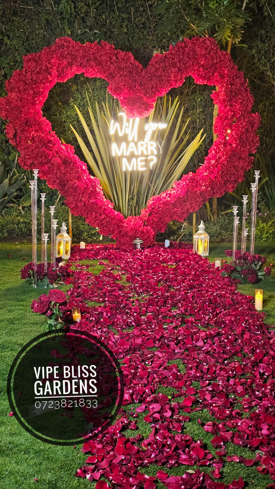 Red floral heart and rose-petal aisle with a Will You Marry Me sign and lanterns at Vipe Bliss Gardens