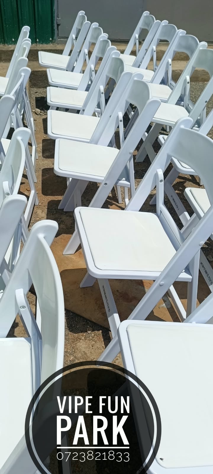 Rows of white padded folding chairs arranged on the grounds ready for guests