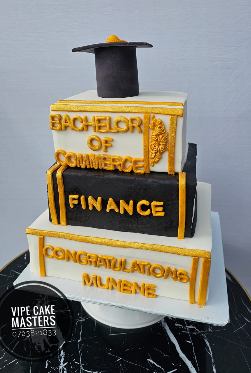 Three-tier black and white graduation cake with gold Bachelor of Commerce Finance lettering