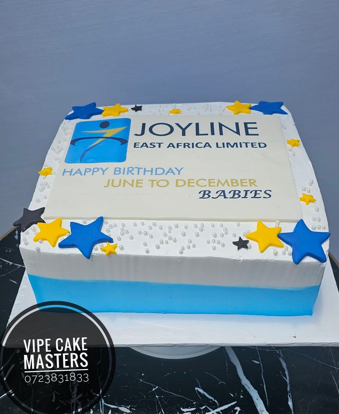 Corporate birthday cake for Joyline East Africa Limited with blue and yellow stars and June to December Babies message