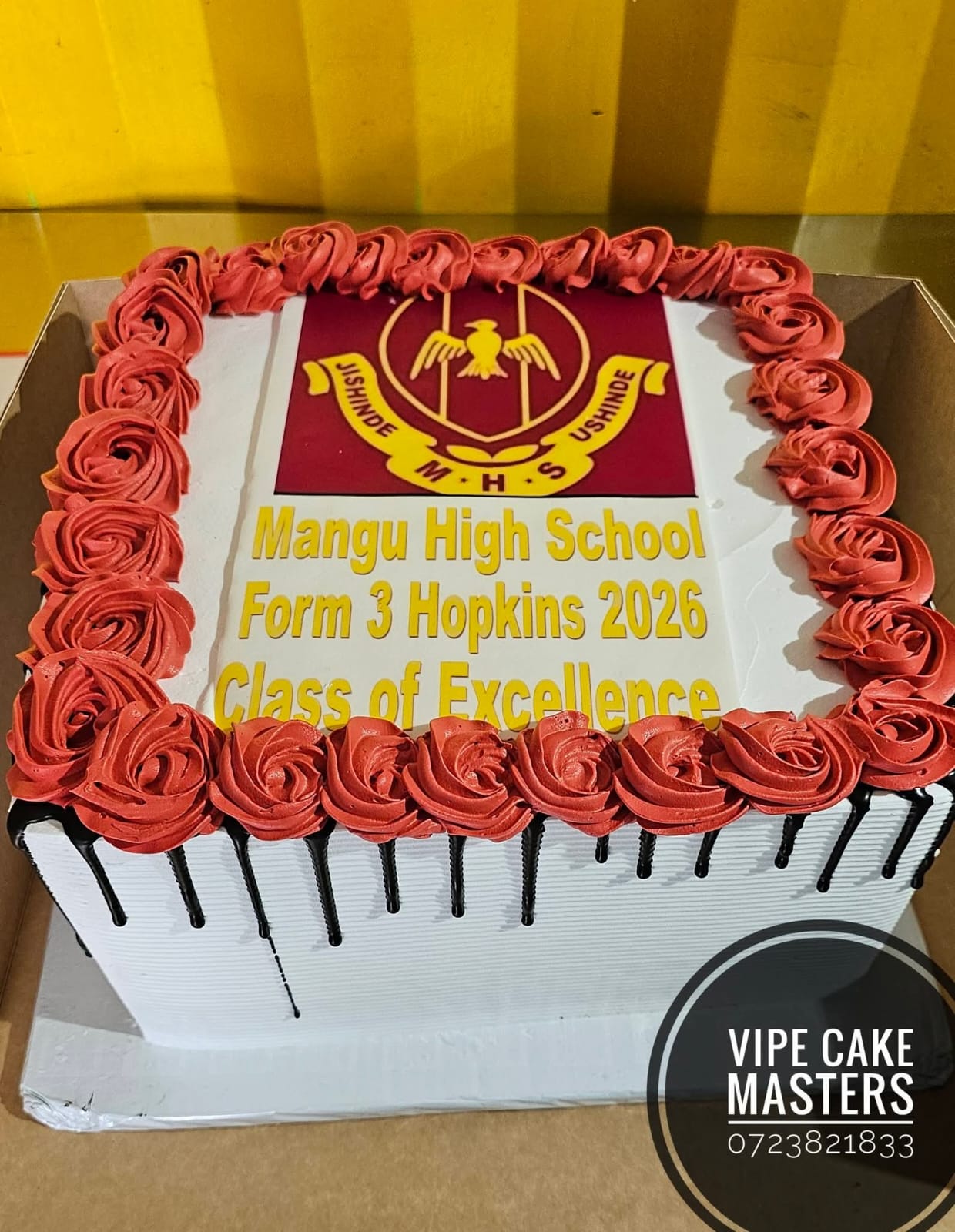 Rectangular school celebration cake with Mangu High School emblem, red roses and Form 3 Hopkins Class of Excellence message