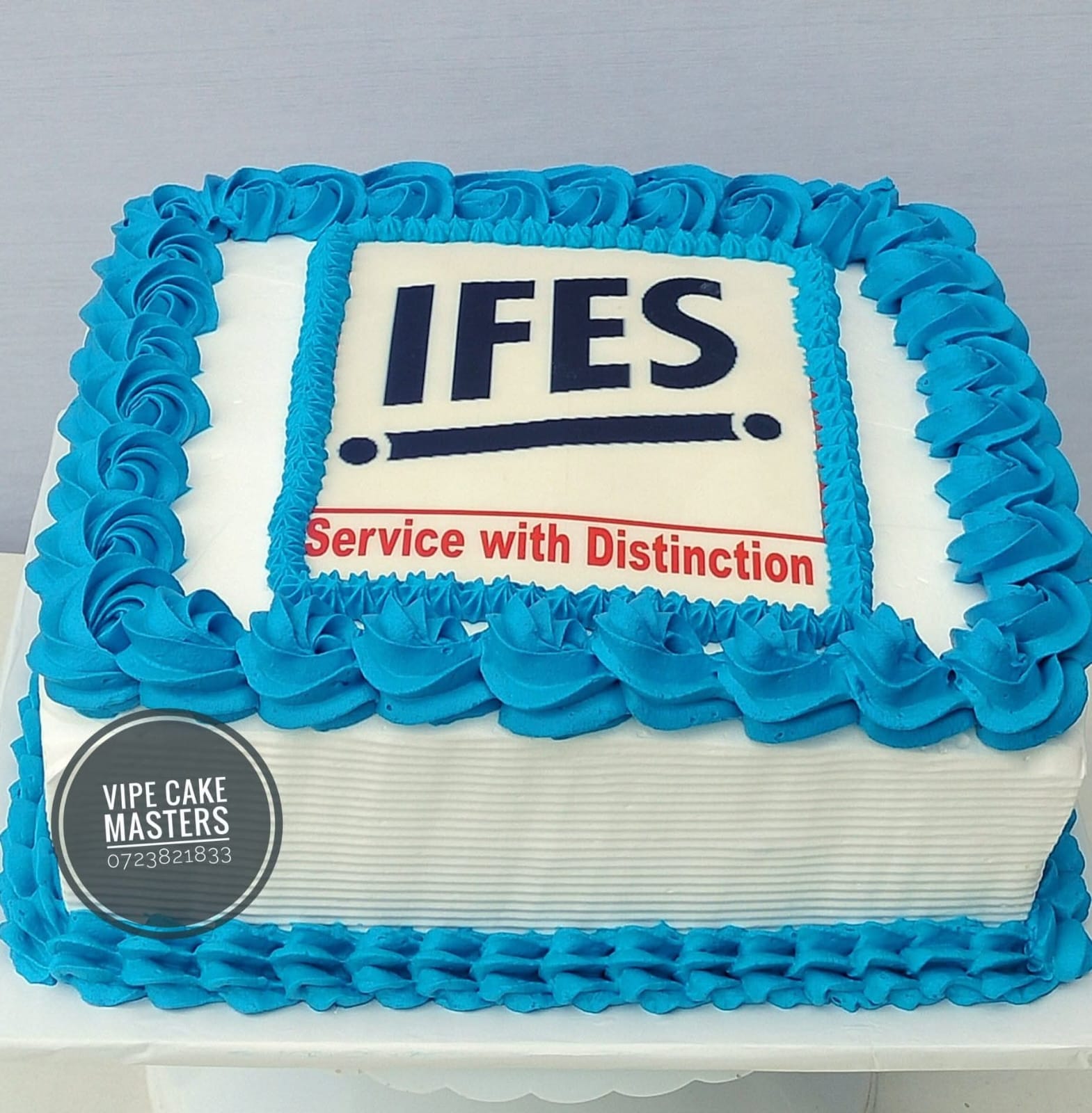 Rectangular corporate cake for IFES with blue rose border and Service with Distinction message