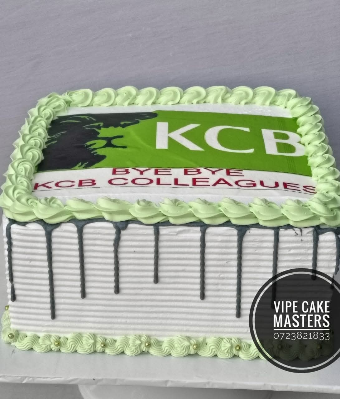 Rectangular KCB farewell cake with green drip icing, lion logo and Bye Bye KCB Colleagues message